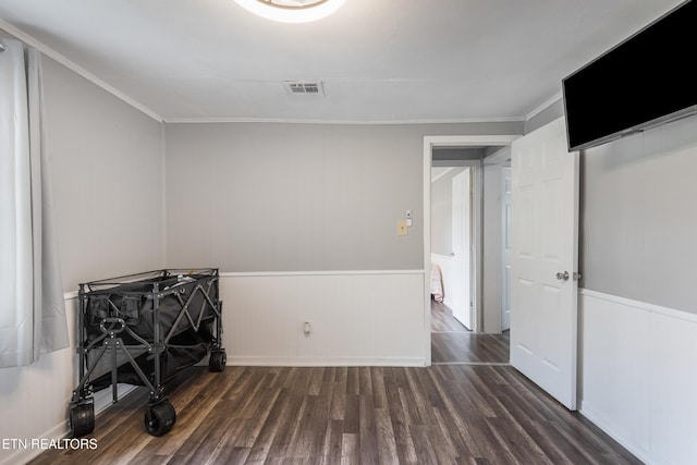 122 Mill Rd, Wartburg, TN 37887 - unfurnished bedroom featuring wood finished floors, ornamental molding, and a decorative wall