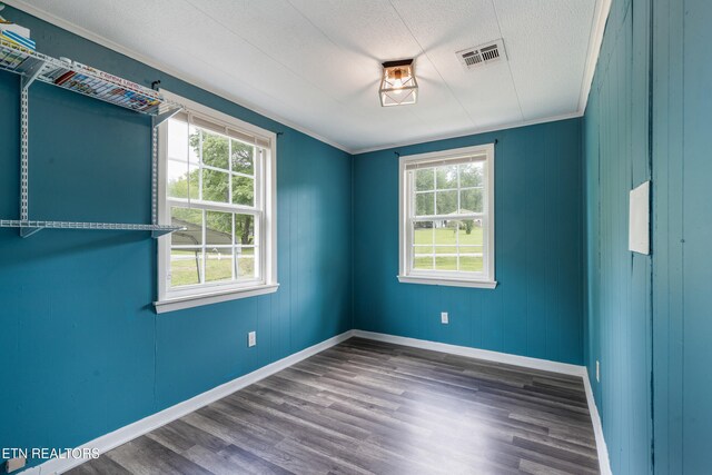 122 Mill Rd, Wartburg, TN 37887 - empty room featuring plenty of natural light, baseboards, wood finished floors, a textured ceiling, and crown molding