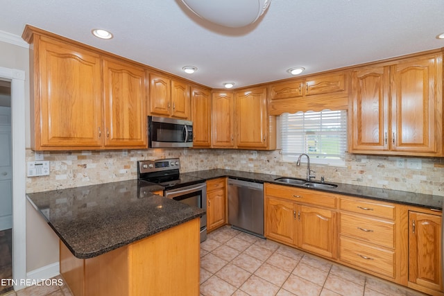 917 Swan Pond Circle Rd, Harriman, TN 37748 - kitchen with stainless steel appliances, a sink, dark stone countertops, a peninsula, and brown cabinets
