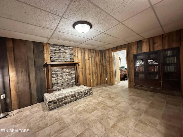 917 Swan Pond Circle Rd, Harriman, TN 37748 - unfurnished living room with wooden walls, a paneled ceiling, and a stone fireplace