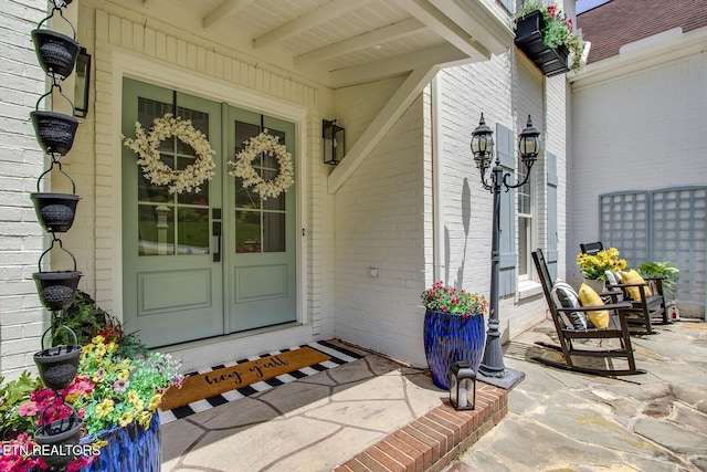 property entrance with french doors and brick siding