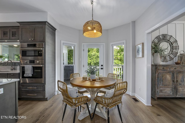 dining space featuring wood finished floors and baseboards