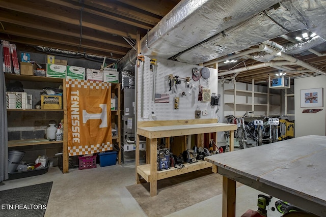 unfinished basement featuring a workshop area