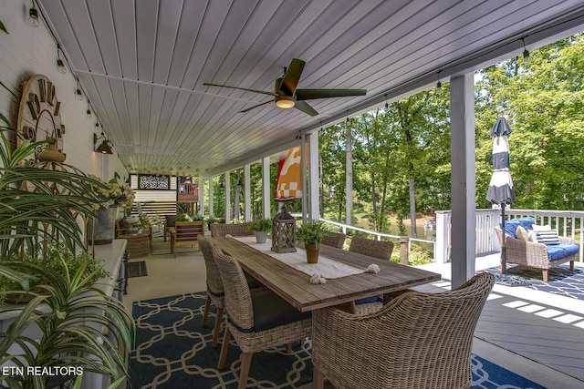 view of patio with an outdoor living space, a ceiling fan, and a wooden deck