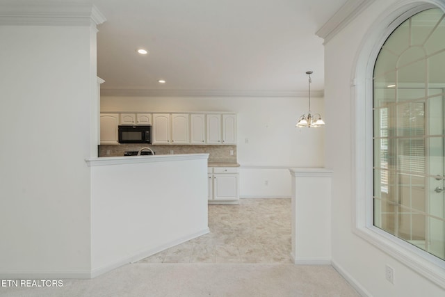111 Devanshire Ct, Oak Ridge, TN 37830 - kitchen featuring black microwave, ornamental molding, tasteful backsplash, a chandelier, and white cabinets