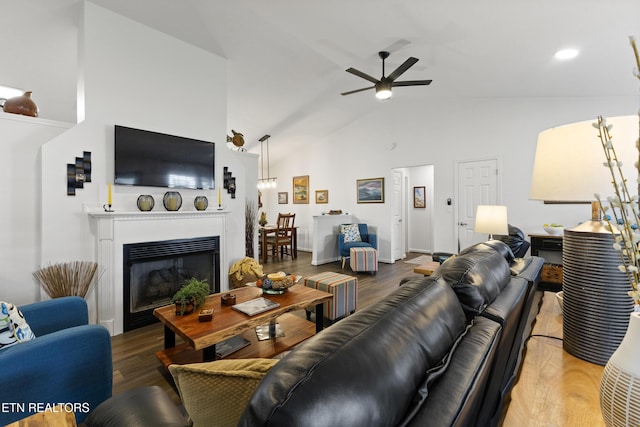 134 Jordan Dr, Caryville, TN 37714 - living room featuring a ceiling fan, high vaulted ceiling, wood finished floors, and a glass covered fireplace
