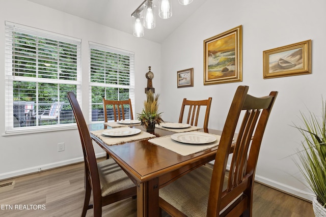 134 Jordan Dr, Caryville, TN 37714 - dining area featuring baseboards, wood finished floors, and vaulted ceiling
