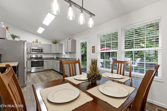134 Jordan Dr, Caryville, TN 37714 - dining space featuring healthy amount of natural light, vaulted ceiling, and wood finished floors