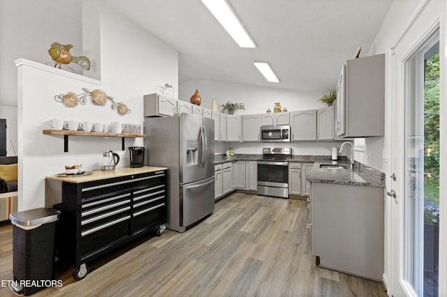 134 Jordan Dr, Caryville, TN 37714 - kitchen featuring appliances with stainless steel finishes, vaulted ceiling, a sink, gray cabinetry, and light wood-type flooring