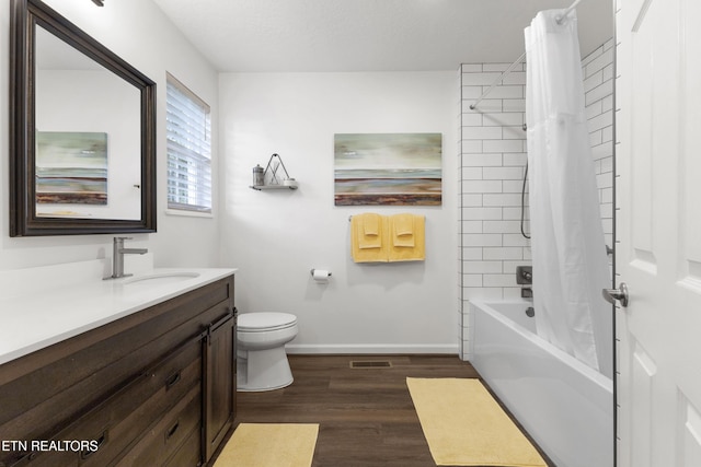 134 Jordan Dr, Caryville, TN 37714 - bathroom with vanity, wood finished floors, shower / bath combo with shower curtain, toilet, and baseboards