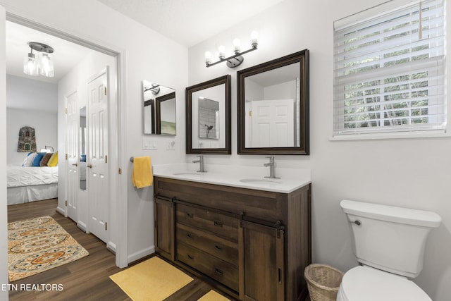 134 Jordan Dr, Caryville, TN 37714 - ensuite bathroom with wood finished floors, double vanity, and toilet