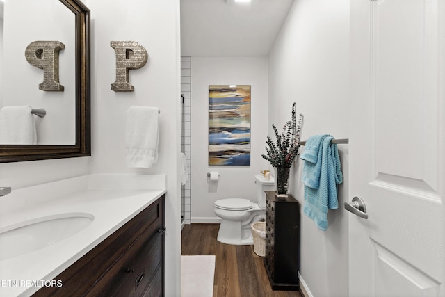 134 Jordan Dr, Caryville, TN 37714 - bathroom featuring vanity, wood finished floors, toilet, and baseboards