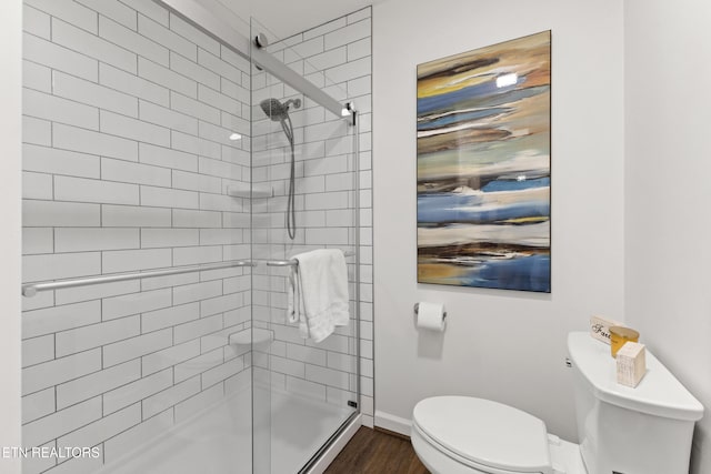 134 Jordan Dr, Caryville, TN 37714 - bathroom featuring toilet, a shower stall, wood finished floors, and baseboards
