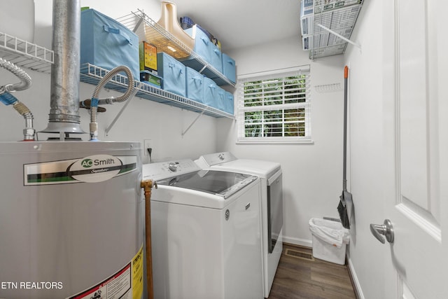 134 Jordan Dr, Caryville, TN 37714 - laundry room featuring water heater, washer and dryer, wood finished floors, and baseboards