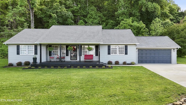 134 Jordan Dr, Caryville, TN 37714 - view of front of home with a porch, concrete driveway, an attached garage, a front yard, and a shingled roof