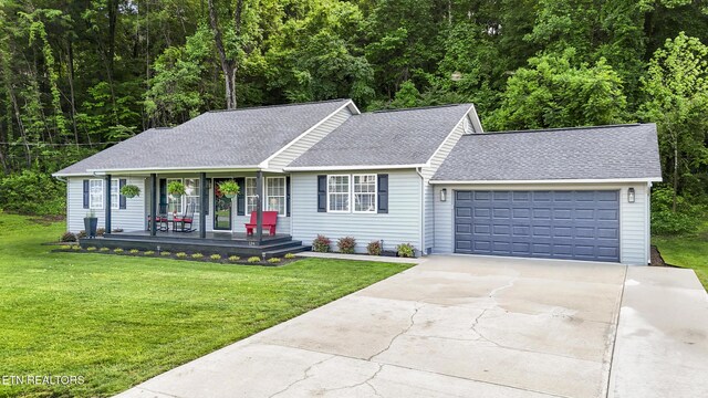 134 Jordan Dr, Caryville, TN 37714 - ranch-style house featuring roof with shingles, a garage, concrete driveway, and covered porch