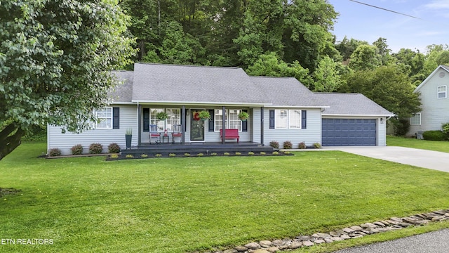 134 Jordan Dr, Caryville, TN 37714 - view of front of home with covered porch, concrete driveway, a front yard, and a garage