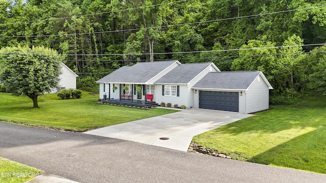 134 Jordan Dr, Caryville, TN 37714 - single story home featuring covered porch, an attached garage, a front yard, concrete driveway, and a wooded view