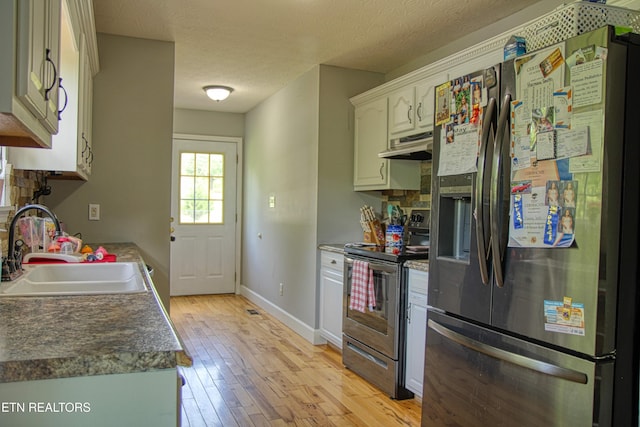 634 Robs Rd, Grimsley, TN 38565 - kitchen featuring appliances with stainless steel finishes, a sink, under cabinet range hood, light wood finished floors, and baseboards