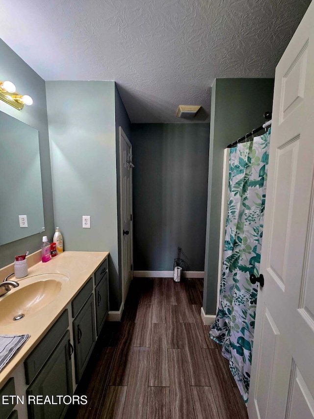 634 Robs Rd, Grimsley, TN 38565 - bathroom featuring wood finished floors, vanity, a textured ceiling, and baseboards