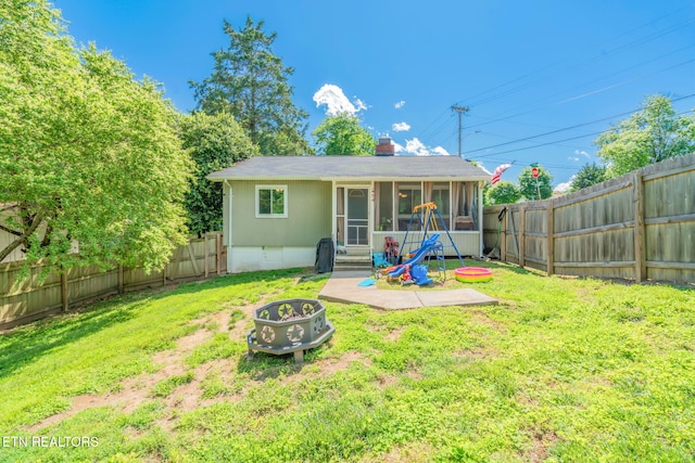 101 Temple Rd, Oak Ridge, TN 37830 - rear view of property with a fire pit, a sunroom, and a chimney