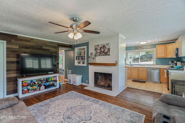 101 Temple Rd, Oak Ridge, TN 37830 - living area with crown molding, a textured ceiling, a ceiling fan, light wood-style floors, and a fireplace