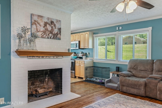 101 Temple Rd, Oak Ridge, TN 37830 - living room with crown molding, wood finished floors, a textured ceiling, ceiling fan, and a fireplace