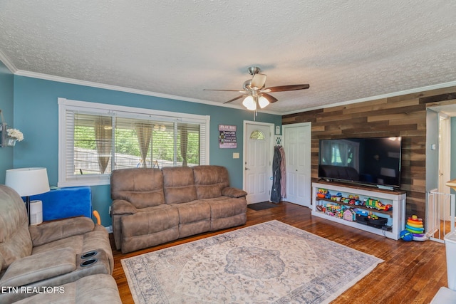 101 Temple Rd, Oak Ridge, TN 37830 - living room featuring a textured ceiling, ceiling fan, ornamental molding, wooden walls, and wood finished floors