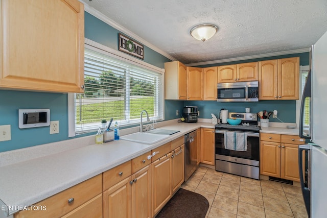 101 Temple Rd, Oak Ridge, TN 37830 - kitchen with appliances with stainless steel finishes, a sink, crown molding, light countertops, and a textured ceiling