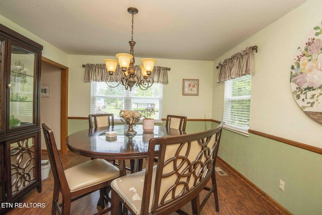 7745 Keswick Rd, Powell, TN 37849 - dining area featuring dark wood finished floors, a chandelier, baseboards, and a textured ceiling