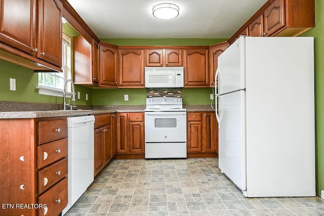 169 Claire St, Benton, TN 37307 - kitchen featuring white appliances, a sink, brown cabinets, stone finish floors, and a textured ceiling