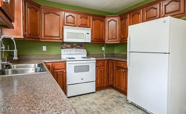 169 Claire St, Benton, TN 37307 - kitchen with white appliances, a sink, brown cabinetry, stone finish flooring, and a textured ceiling