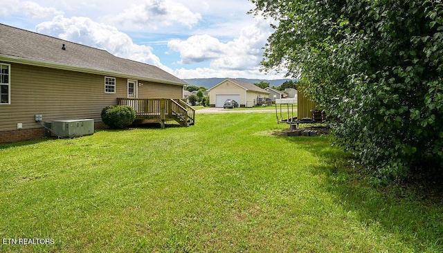 169 Claire St, Benton, TN 37307 - view of grassy yard featuring central AC and a garage