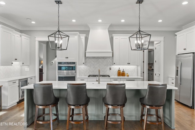 209 Fence Post Ln, Knoxville, TN 37934 - kitchen featuring appliances with stainless steel finishes, beverage cooler, a chandelier, custom exhaust hood, and backsplash