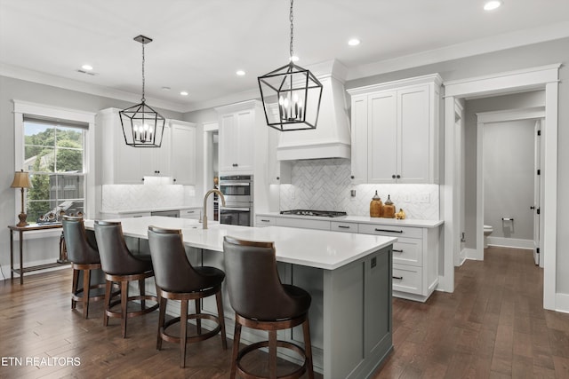 209 Fence Post Ln, Knoxville, TN 37934 - kitchen featuring a chandelier, light countertops, a kitchen island with sink, dark wood-type flooring, and recessed lighting