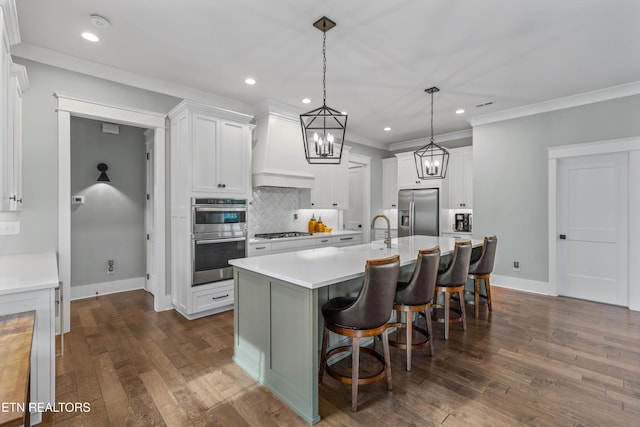 209 Fence Post Ln, Knoxville, TN 37934 - kitchen featuring stainless steel appliances, backsplash, light countertops, custom range hood, and a center island with sink