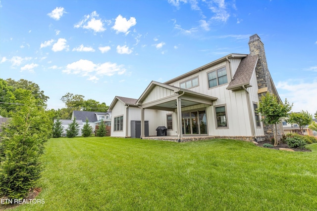 209 Fence Post Ln, Knoxville, TN 37934 - back of property featuring board and batten siding, a chimney, a patio, ceiling fan, and a shingled roof