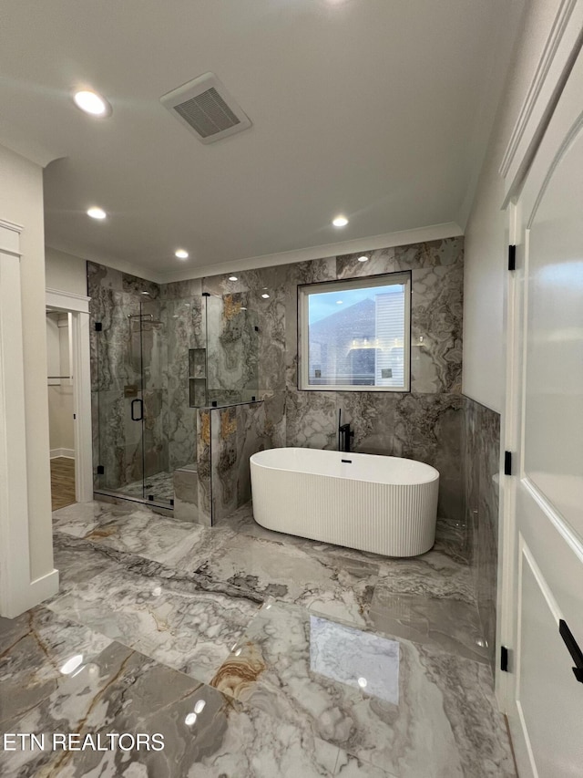 full bath featuring a marble finish shower, a soaking tub, marble tiled flooring, ornamental molding, and a spacious closet