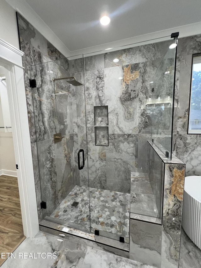 full bath featuring a marble finish shower, recessed lighting, radiator heating unit, and crown molding