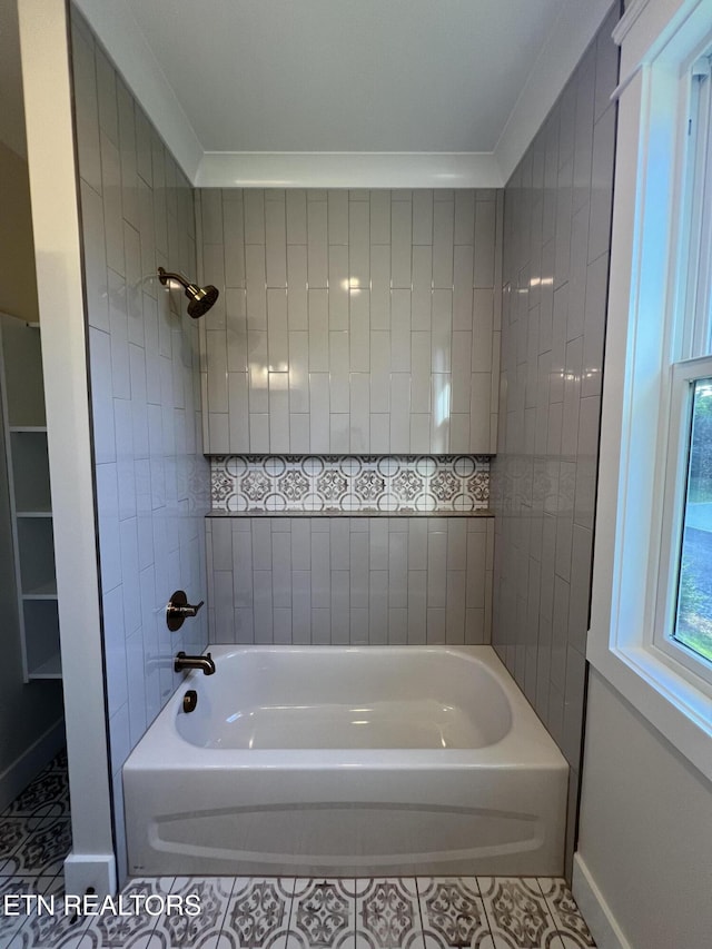 full bath featuring shower / tub combination, tile patterned floors, and baseboards