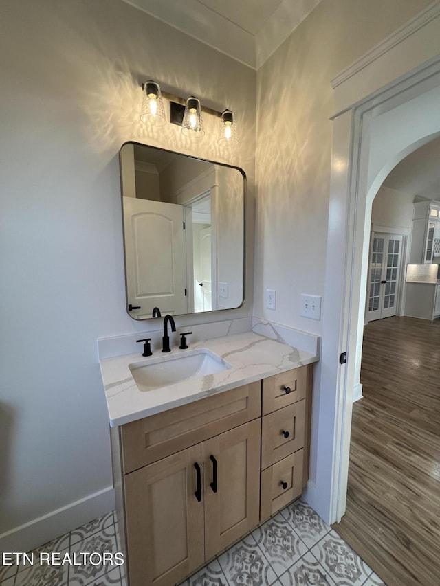 bathroom featuring baseboards, vanity, and tile patterned flooring