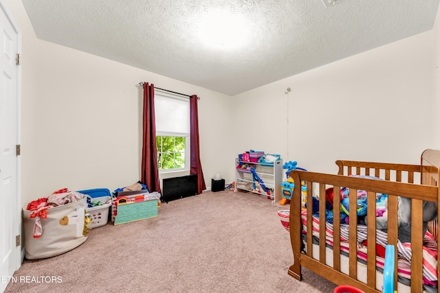bedroom featuring carpet floors and a textured ceiling