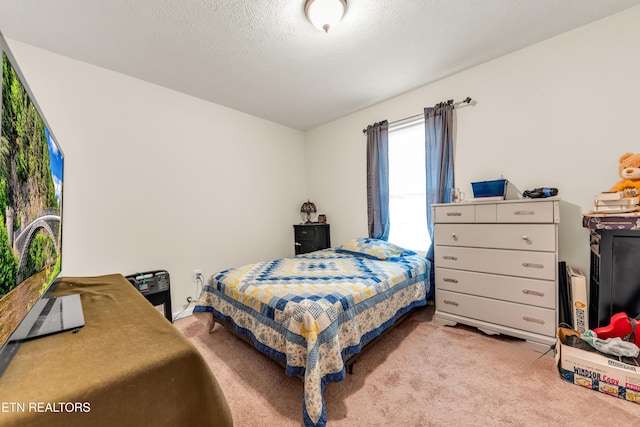 bedroom featuring carpet and a textured ceiling