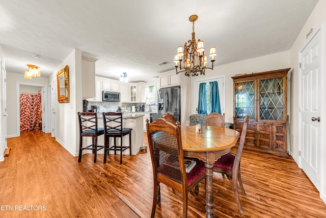 dining room featuring a chandelier and light wood finished floors
