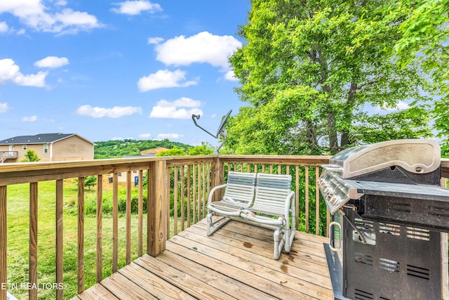 deck with area for grilling and a yard