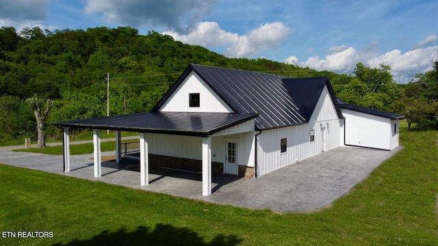 151 Clear Creek Rd, Newport, TN 37821 - back of property featuring a yard, metal roof, and a wooded view