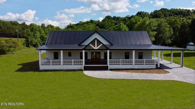151 Clear Creek Rd, Newport, TN 37821 - farmhouse-style home with covered porch, a front lawn, metal roof, and a carport