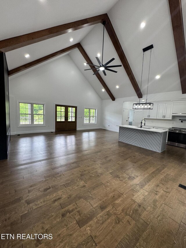 151 Clear Creek Rd, Newport, TN 37821 - unfurnished living room featuring high vaulted ceiling, dark wood-style floors, beamed ceiling, a sink, and plenty of natural light