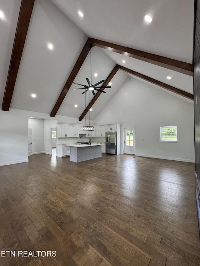 151 Clear Creek Rd, Newport, TN 37821 - unfurnished living room featuring beamed ceiling, a ceiling fan, baseboards, dark wood finished floors, and high vaulted ceiling