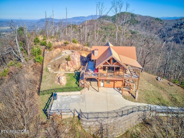 aerial view of property and surrounding area featuring a mountain backdrop